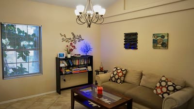Cozy common area with a sofa and bookshelves