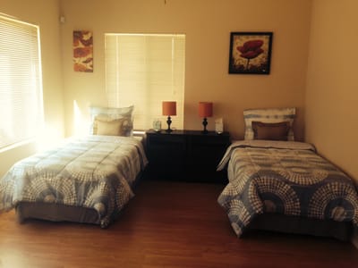 Shared resident room with two beds and lamps