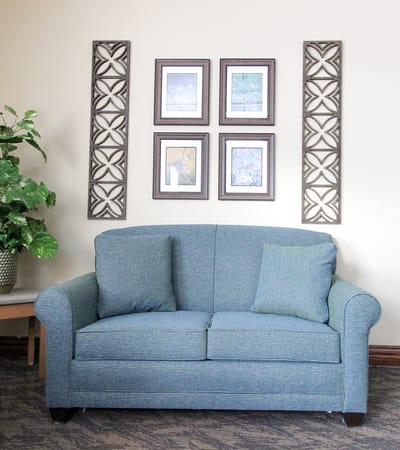 Cozy seating area with framed pictures on the wall