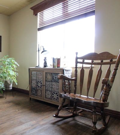Cozy interior corner with a rocking chair and lamp