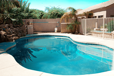Outdoor pool area with surrounding greenery