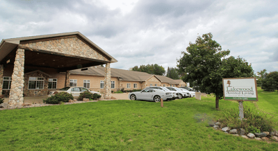 Front exterior of Lakewood Assisted Living facility with parking area