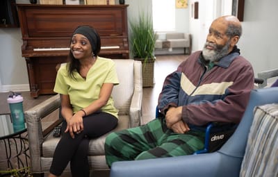 Care staff and resident interacting in a common area