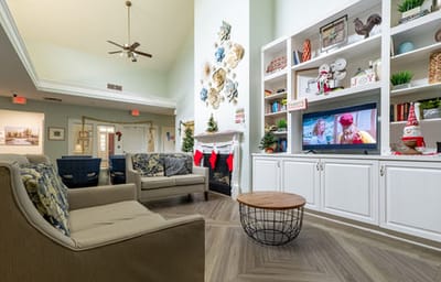 Bright and inviting common area with seating and a TV
