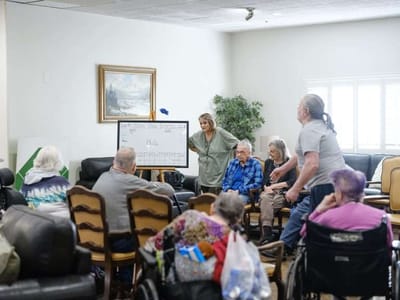 Residents participating in an activity with staff support