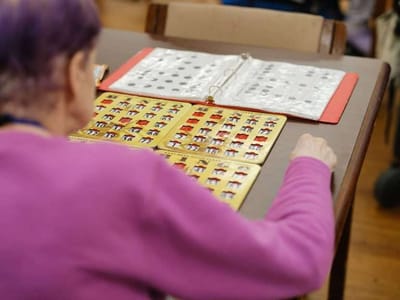 Resident playing bingo at a table
