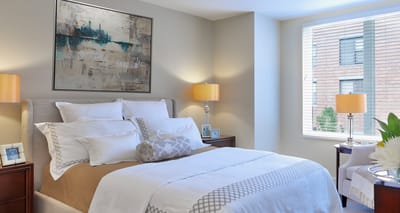 A well-furnished private bedroom in a senior living facility