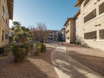 Walkway through landscaped outdoor space of a facility