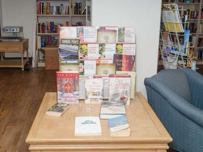 Books displayed on a table in a common area