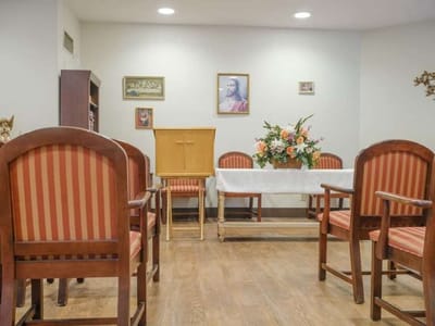 Interior view of a small common area with chairs and flowers
