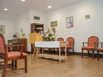 Common area with chairs and a table in an interior setting