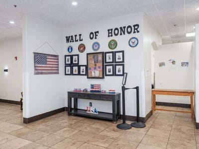 Interior view of the Wall of Honor with flags and photos
