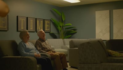 Two residents enjoying time together in a lounge area