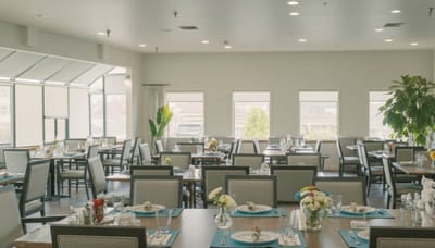 Interior dining room with tables set for meals