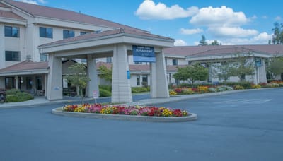 Exterior view of Grande Ronde Retirement Residence with flower beds
