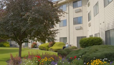 Residents enjoying a garden area outside the facility