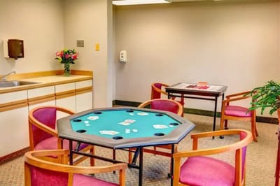 Interior activity room with poker table and chairs