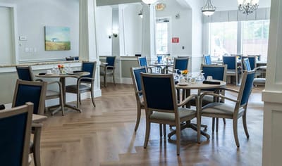 Dining area with tables and chairs set for meals