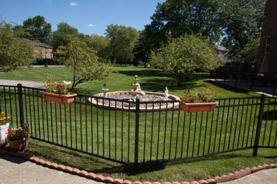 Citadel at Saint Benedict, Nursing Home in Niles, IL — Garden fountain surrounded by well-maintained grass and trees