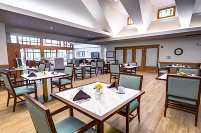 Elegant dining area with tables set for meals at The Auberge at Oak Village