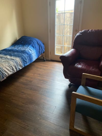 Chianti Joy LLC, assisted living in Stockton, CA — Empty room with a bed and two chairs