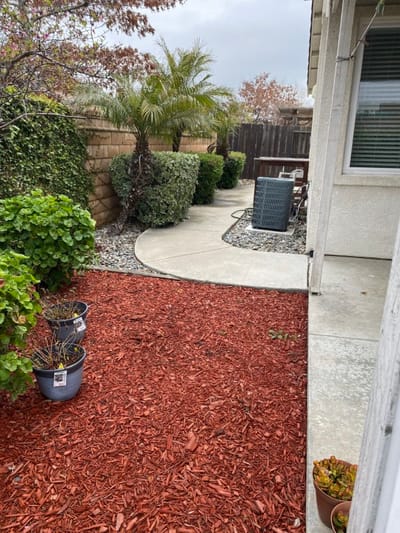 Chianti Joy LLC, assisted living in Stockton, CA — Landscaped pathway with red mulch and greenery