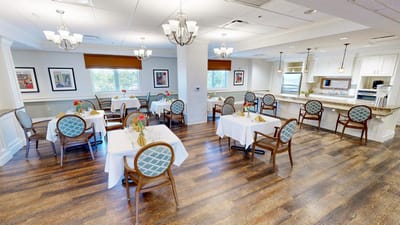 Bright dining room with tables set for meals.