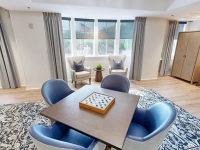 Bright common area with seating and a game table