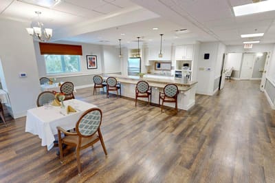 Bright dining area with tables and chairs.