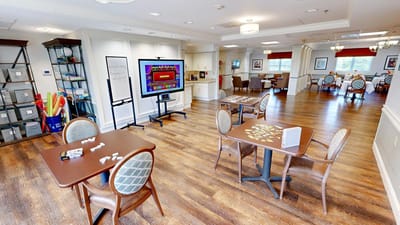 Bright activity room with tables and games available