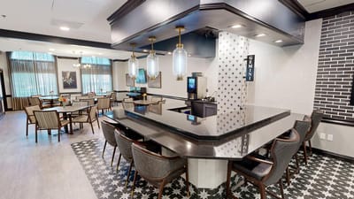 Modern dining area with bar seating and decor.