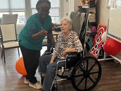 Staff member assisting a resident in a common area