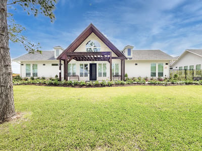 Exterior view of a senior living building with landscaped yard