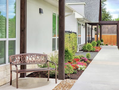 Welcoming bench surrounded by flowers and pathways