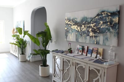 Bright lobby area with plant decorations and artwork