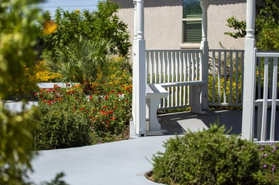 A gazebo surrounded by colorful flowers in a garden.
