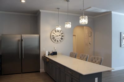 Bright kitchen area with modern decor and clock