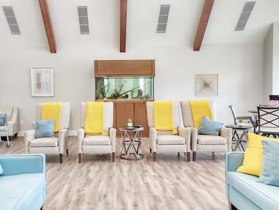 Bright lounge area with comfortable seating and an aquarium