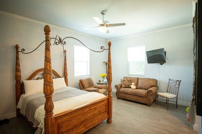 Cozy bedroom with a wooden bed and seating area