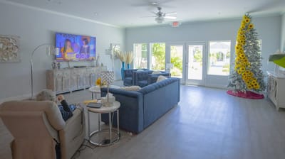 Interior lounge area with a resident watching TV