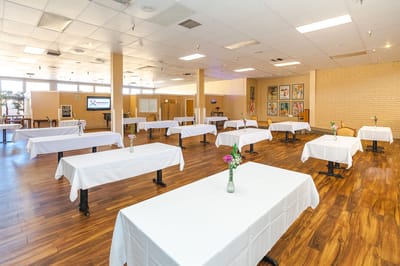 Dining room set up for an event with floral centerpieces