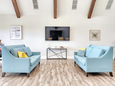Welcoming common area with seating and TV