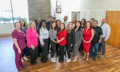 Staff members posing in the facility's lobby