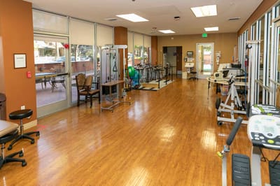 Well-equipped physical therapy room with exercise equipment