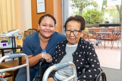 A staff member with a resident in a communal area