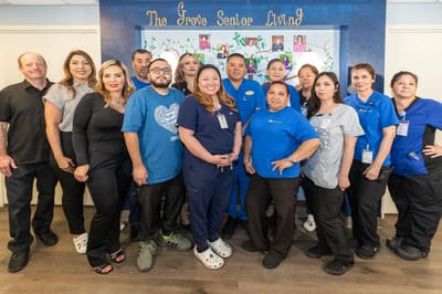Staff members posing together in a common area