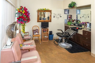 Hair salon area with seating and mirrors
