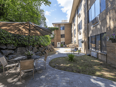 Outdoor seating area with plants and a pathway