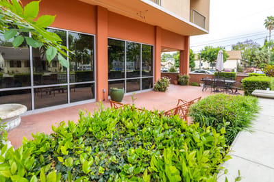 A landscaped outdoor area with seating and plants