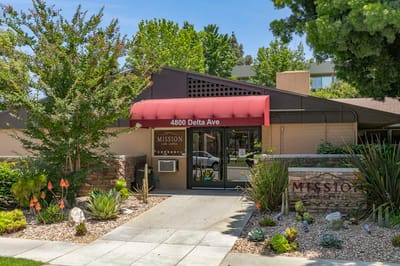 Exterior view of Mission Care Center with garden